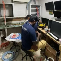 This image shows my team at work in a control room, managing the complex wiring required for an integrated security and IT network. I ensure every connection is secure and organized for reliable performance.