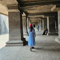 Walking through the massive stone pillars inside one of the Ellora caves. The play of light and shadow in these ancient halls is something I often try to capture in my art.