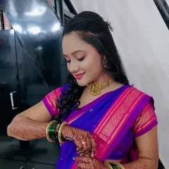 A candid moment showing the client adjusting her green bangles, which add a lovely pop of colour to her look.