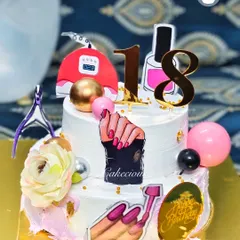 A fun and detailed cake for a nail artist's 18th birthday. It's decorated with everything from nail polish bottles to a UV lamp.
