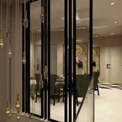 Looking down from the staircase, you can see how the black-framed glass partitions create a visual link to the living area. This design choice provides separation while maintaining a sense of connection and flow between spaces.