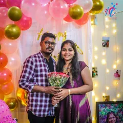 A happy couple posing in front of our birthday decorations. The balloon arch and fairy light backdrop create the perfect spot for memorable photos.