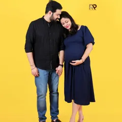 A bright and joyful couple's portrait. The simple outfits and the vibrant yellow backdrop create a modern, happy, and energetic feel.