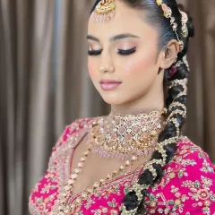 A sleek and elegant braided hairstyle, intricately woven and adorned with accessories. This style is perfect for keeping hair neatly off the face while looking incredibly regal.