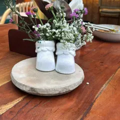 A close-up of our creative baby sock centerpiece. This unique detail is perfect for baby showers, adding a touch of whimsy and thoughtfulness to the table decor that guests always remember.