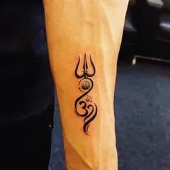 A classic combination of the Trishul and Om, this tattoo is a powerful emblem of divine energy. We designed it to flow with the natural lines of the forearm, creating a balanced and striking piece.