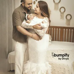From two to three. This portrait captures the new family unit, with the mother beautifully dressed and holding their precious newborn, showcasing the joy of this new chapter.