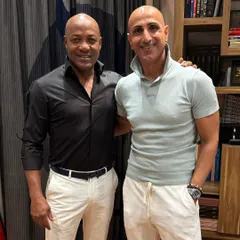 It was an honor to dress the legendary cricketer Brian Lara. This look, featuring a sharp black shirt and crisp white trousers, is a testament to how I tailor style for champions.