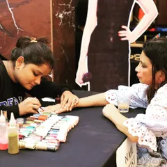 A professional nail artist provides on-the-spot manicures for guests. This is a popular and engaging activity for events focused on wellness, beauty, or simply offering a touch of pampering for attendees.