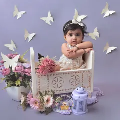 This 10-month-old sitter is so curious and alert. I used a lovely lavender background with butterfly props to create a sweet and whimsical scene for her milestone portrait.