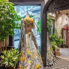 Our design philosophy for retail spaces is to let the product take center stage. Here, a neutral backdrop of lime-plastered walls and carefully curated lighting ensures this stunning designer lehenga is the main focus, demonstrating how thoughtful interior design can enhance the merchandise.
