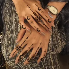 A very modern and minimalist design for Eid, featuring crescent moons and stars. This is perfect for someone who wants a chic and symbolic henna tattoo.