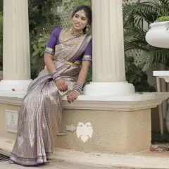 Vaishnavi looks so elegant in this violet silk blouse I designed for her. The beauty of this piece is in its simplicity, with traditional borders on the neckline and sleeves adorned with intricate zari, glass beads, and sequins for a touch of charm.