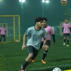 Action on the field. This image captures the electric energy and unbreakable focus of our players during a competitive match.