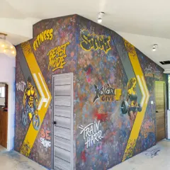 We bring high energy to fitness spaces with dynamic graffiti art. This project for One More Rep gym in Mangalore features motivational text and powerful figures to inspire every workout.