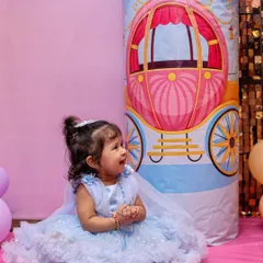 A candid shot of the birthday girl, Shrinika, looking adorable in her blue party dress. We always look for those unposed moments that perfectly capture a child's personality.