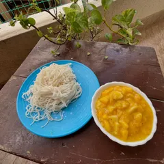 A comforting and traditional combination of Otthu Shavige (freshly pressed rice noodles) and Sheekarne (a sweet mango and coconut milk curry).