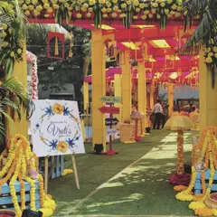Welcome your guests to the Haldi ceremony with a burst of color. This vibrant entrance uses traditional marigold garlands, bright yellow and pink structures, and a personalized welcome sign to create a cheerful and festive atmosphere.