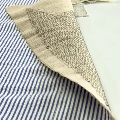 This is a close-up of pad stitching, or Kulti as we call it in India. This meticulous hand-stitching technique attaches the inner hair canvas to the lapel fabric, creating the graceful and firm roll that defines a high-quality jacket.