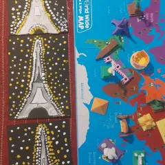 A close-up of the Eiffel Tower paintings and the world map with monuments. This activity helps connect the abstract idea of a landmark with its physical location.