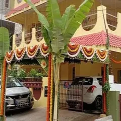Even a simple *chappra* can make a house feel festive and ready for a *Gruha Pravesh*. This entrance features banana plants, a symbol of prosperity, and colorful marigold garlands, creating a warm, traditional welcome for family and friends.