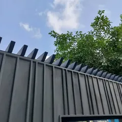 The top detail of the minimalist boundary wall, featuring angled coping elements. This small but important detail adds a sharp, geometric finish to the wall, protecting it from the elements while contributing to the overall modern aesthetic.
