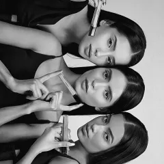 A striking black and white version of the group beauty shot, emphasizing composition and form for an artistic campaign.