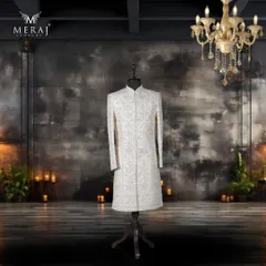Inspired by Persian heritage, this off-white silk sherwani is a work of art. It features intricate aari and sequin detailing, elevated by a stunning blend of blue and pink Meenakari embroidery for a truly unique groom's outfit.