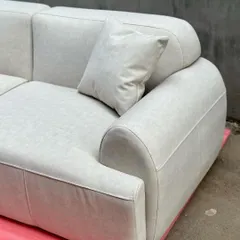 A detail shot of the modern sofa's armrest and cushion, showing the clean lines and quality of the fabric and stitching.