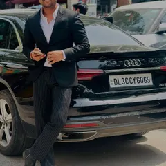 Posing with my car, a symbol of the success that comes from hard work and dedication to my clients.