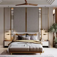 This bedroom is all about creating a sanctuary. We used soothing shades of grey, textured fabrics, and golden inlays for a touch of luxury. The large mirror behind the bed reflects light and adds depth to the space.