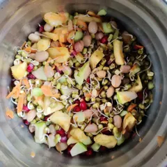 This vibrant salad is packed with fiber and protein. It features sprouted moong, beans, fresh vegetables, and fruits. It's a perfect example of a filling, nutrient-dense meal that supports weight loss and gut health.