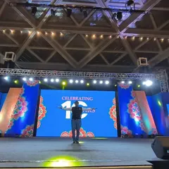 On stage for the 10th-anniversary celebration of Logixhealth. This massive setup includes multiple LED screens, a full lighting truss, and a stage ready for a huge corporate crowd.