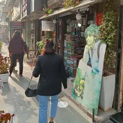A candid moment of me walking towards a bookstore, part of my yearly tradition of buying a new book to start the year. This shares a personal ritual with my audience.