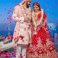 The climax of the ceremony, a shower of petals celebrating the union. We focus on capturing the energy and emotion of such peak moments, with the couple surrounded by the joy of their loved ones.