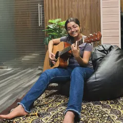 Find your comfort zone and your creative spark. This is what our jam sessions look like: relaxed, inspiring, and all about the music. Here, a student enjoys a moment of musical flow on the acoustic guitar.