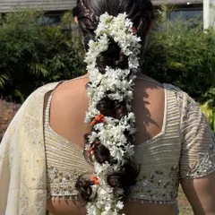 A detailed shot of the stunning floral braid, a perfect hairstyle for a traditional wedding function.