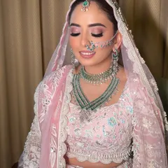 With eyes closed, you can appreciate the soft blend of pink and shimmer on the lids. This is a perfect example of a romantic and dreamy bridal eye makeup look.