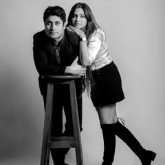 A stylish, posed black and white studio portrait. This showcases a more classic and formal side of couple photography, with a touch of old-school glamour.