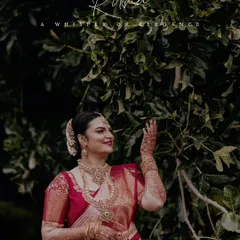 An elegant portrait of a South Indian bride in a beautiful silk saree, captured in a natural outdoor setting.
