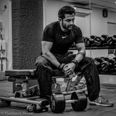 A moment of rest between sets. Strength training is a grind, but it's the foundation of a powerful fighter.