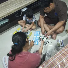 A family bonding moment over a Lego project. Building together is a fantastic way to develop fine motor skills, learn to follow instructions, and practice teamwork.
