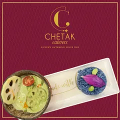 A vibrant and colourful Thai Green Curry with vegetables and lotus stem, served in a coconut shell with a side of butterfly pea flower rice. This dish is a journey to Southeast Asia.