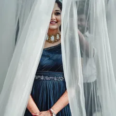 An artistic shot of my blue georgette gown. The focus is on the exquisite embroidery along the waist and the one-shoulder neckline, with floor-length rushing details that add texture and elegance.