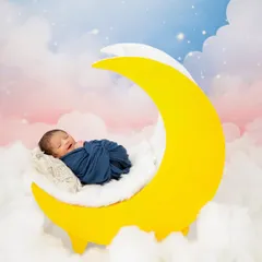 Let your baby's dreams take flight with this magical moon and clouds setup. I love creating whimsical and imaginative scenes for newborn photoshoots.
