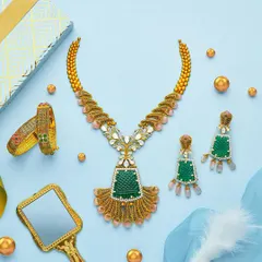 Another stunning set from the PNGadgil summer campaign. The composition is balanced and airy, letting the beautiful green and gold necklace set be the hero while the props add a touch of elegance.