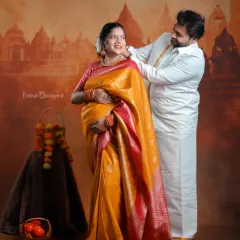 We celebrate your journey into parenthood by weaving in the beauty of your traditions. This couple's portrait, set against a classic backdrop, captures the warmth and richness of a South Indian maternity celebration.