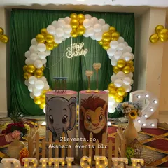 A fun jungle theme featuring Lion King characters on the pedestals. The circular balloon arch in gold and white, paired with a 'Happy Birthday' neon sign, makes for a great photo backdrop.
