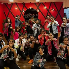 A happy group photo from our March classes. The smiles and pointing fingers show the fun and camaraderie that we build in every session.