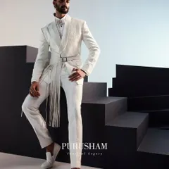 I believe white is a power statement. This ensemble redefines the classic white suit with a modern, architectural silhouette, featuring a structured jacket with a dramatic, fringed belt. It is a look for the man who appreciates classic tailoring but demands a contemporary edge.